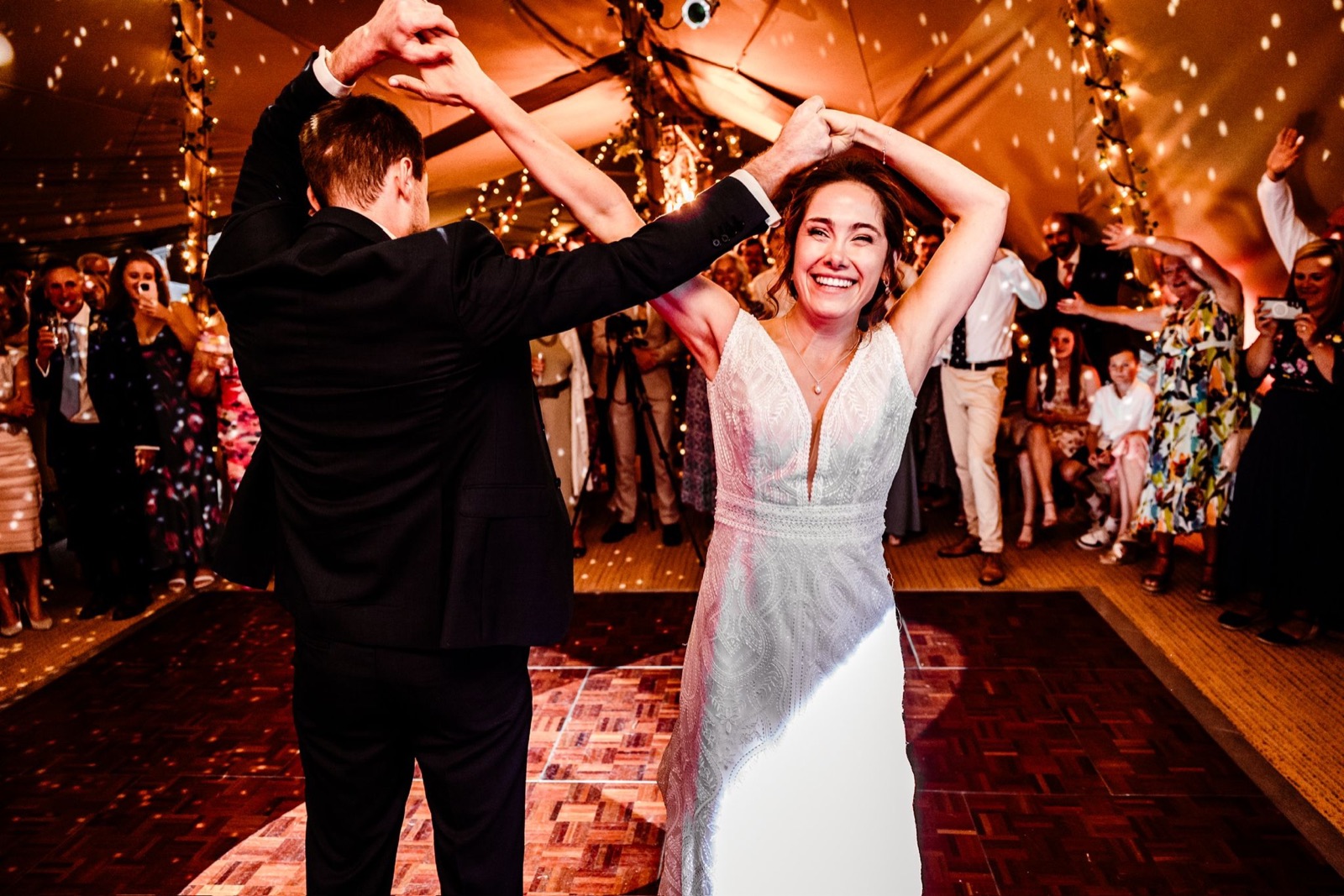 Bride and groom dancing during a warm wedding reception