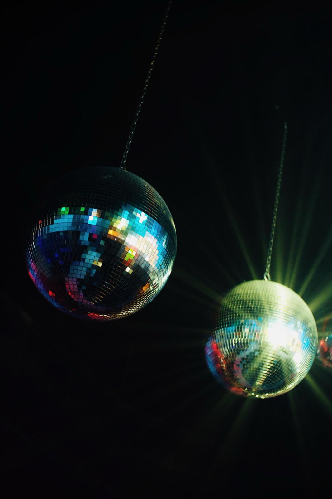 Mirror balls and warm party lighting representing event atmosphere
